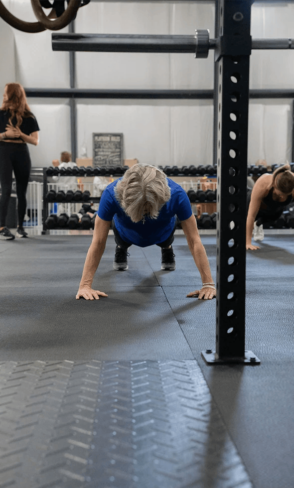 old woman doing push-ups at Grow Strength & Training